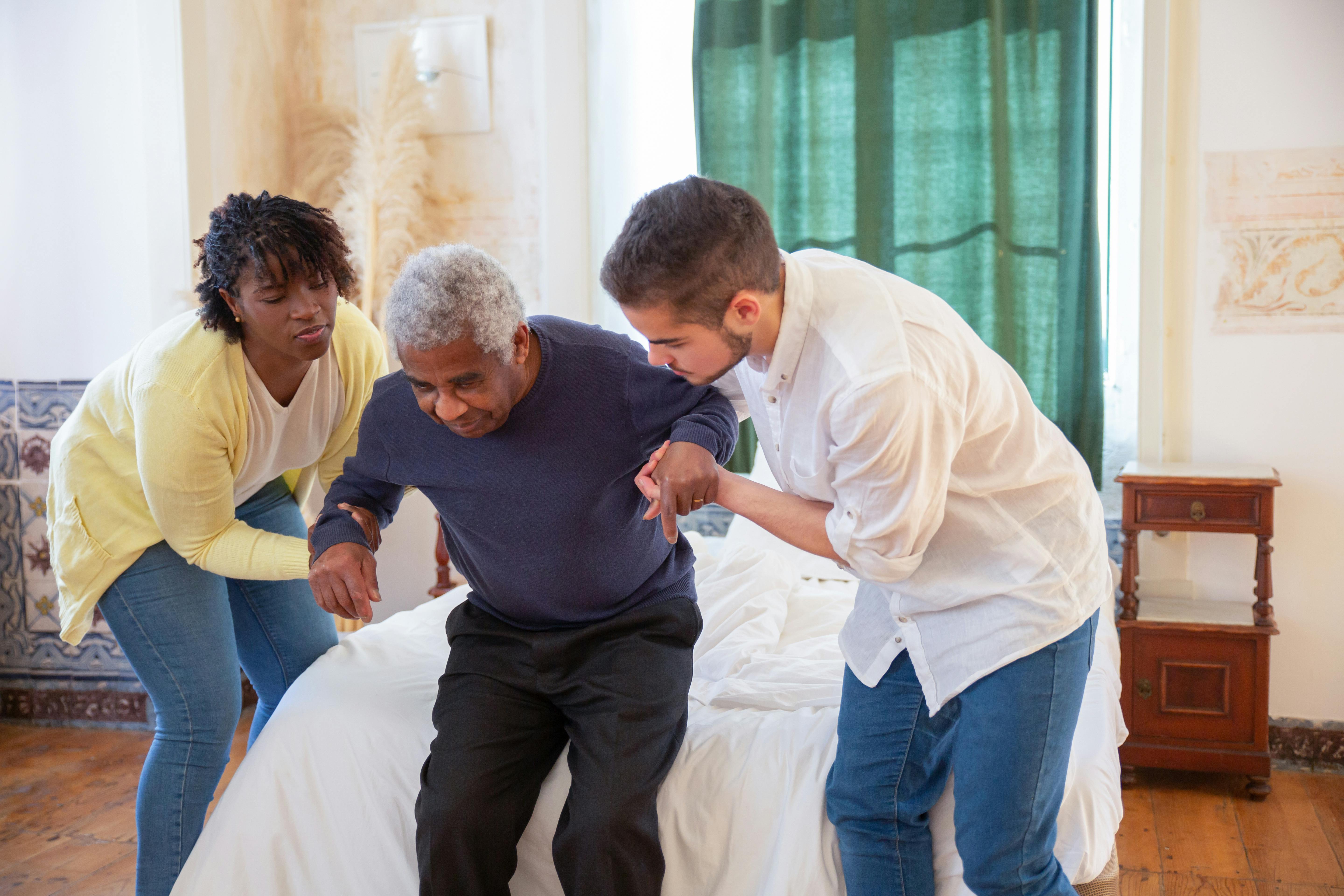Healthcare staff supporting a patient in a care setting